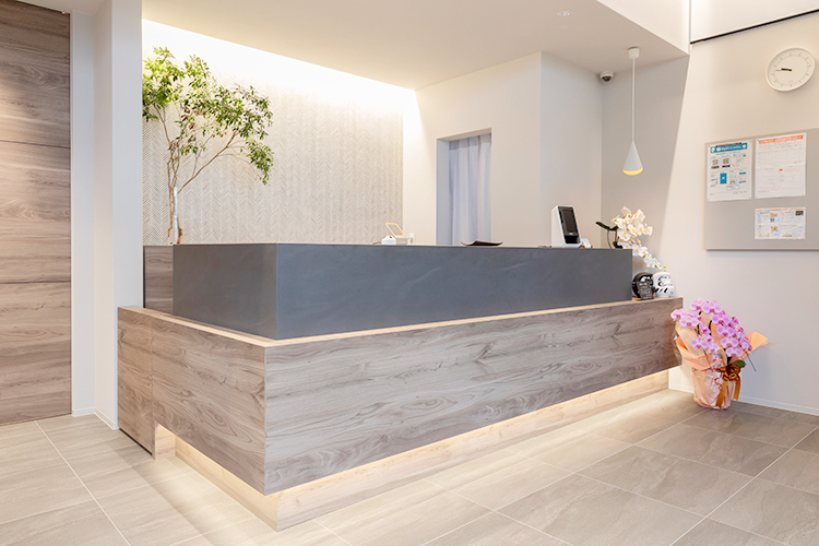 高松イイハ歯科 高松市 受付では、スタッフが笑顔で患者を迎え入れる