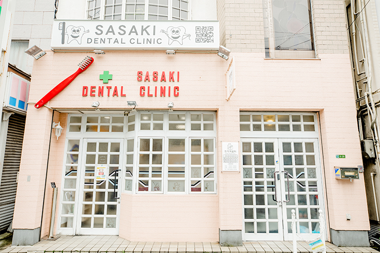 佐々木歯科医院 大阪市此花区 ピンクの壁に赤い歯ブラシが目を引く外観