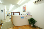 六つ門きくち歯科医院 久留米市 すっきりと整理された受付。スタッフが明るい笑顔で患者を迎える
