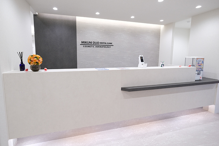 三国デュオ歯科・おとなこども矯正歯科・美容皮膚科 大阪市淀川区 清潔感あふれる受付では、爽やかな笑顔でスタッフが出迎える