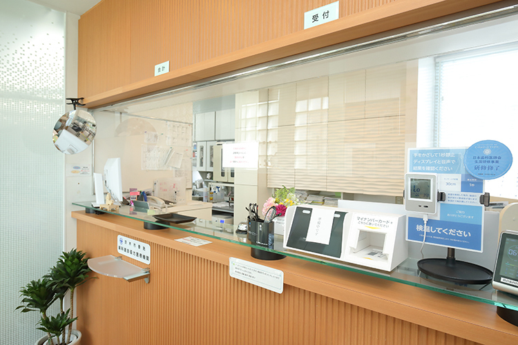朝倉歯科医院 茨木市 木目を基調とし、落ち着いた雰囲気の受付