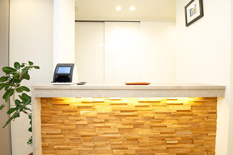 SEED DENTAL CLINIC 大阪市住吉区 院内に入り左手に進むと優しい色彩の受付がある